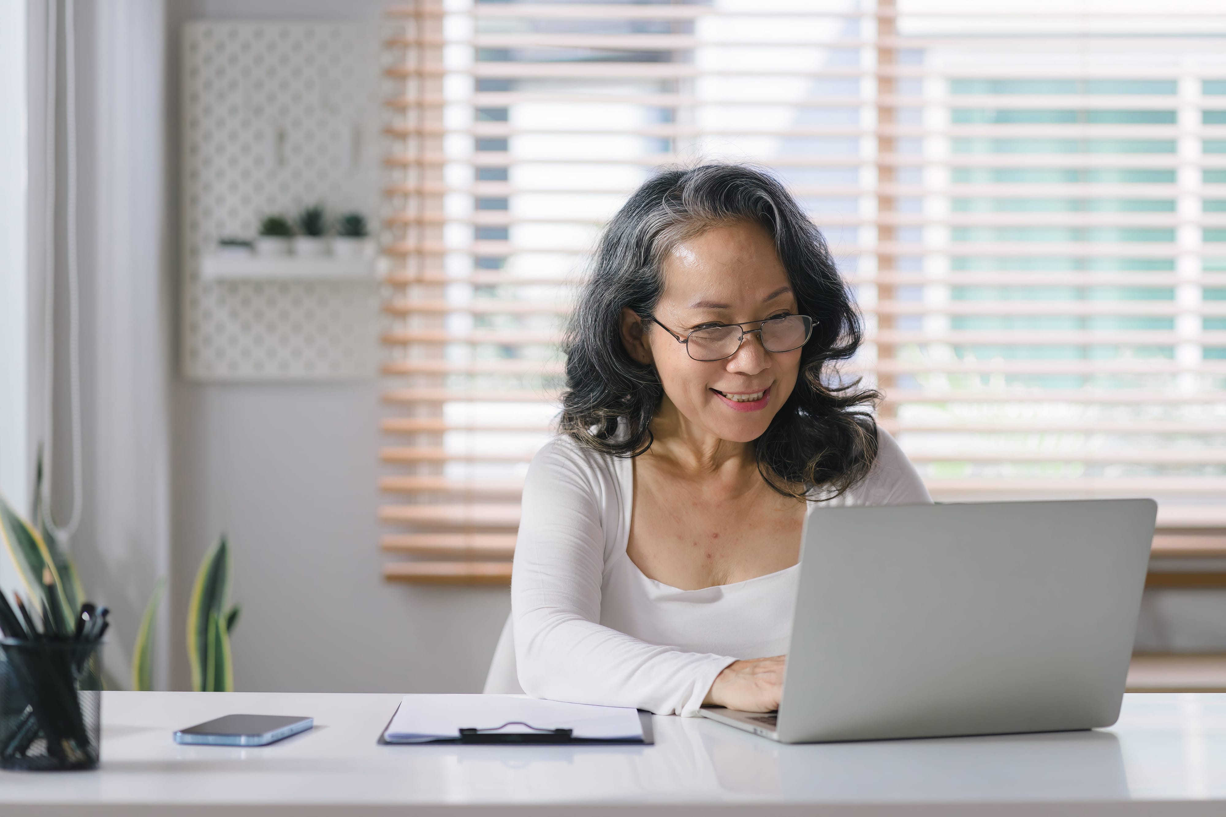 A woman using her laptop from the comfort of her own home. 