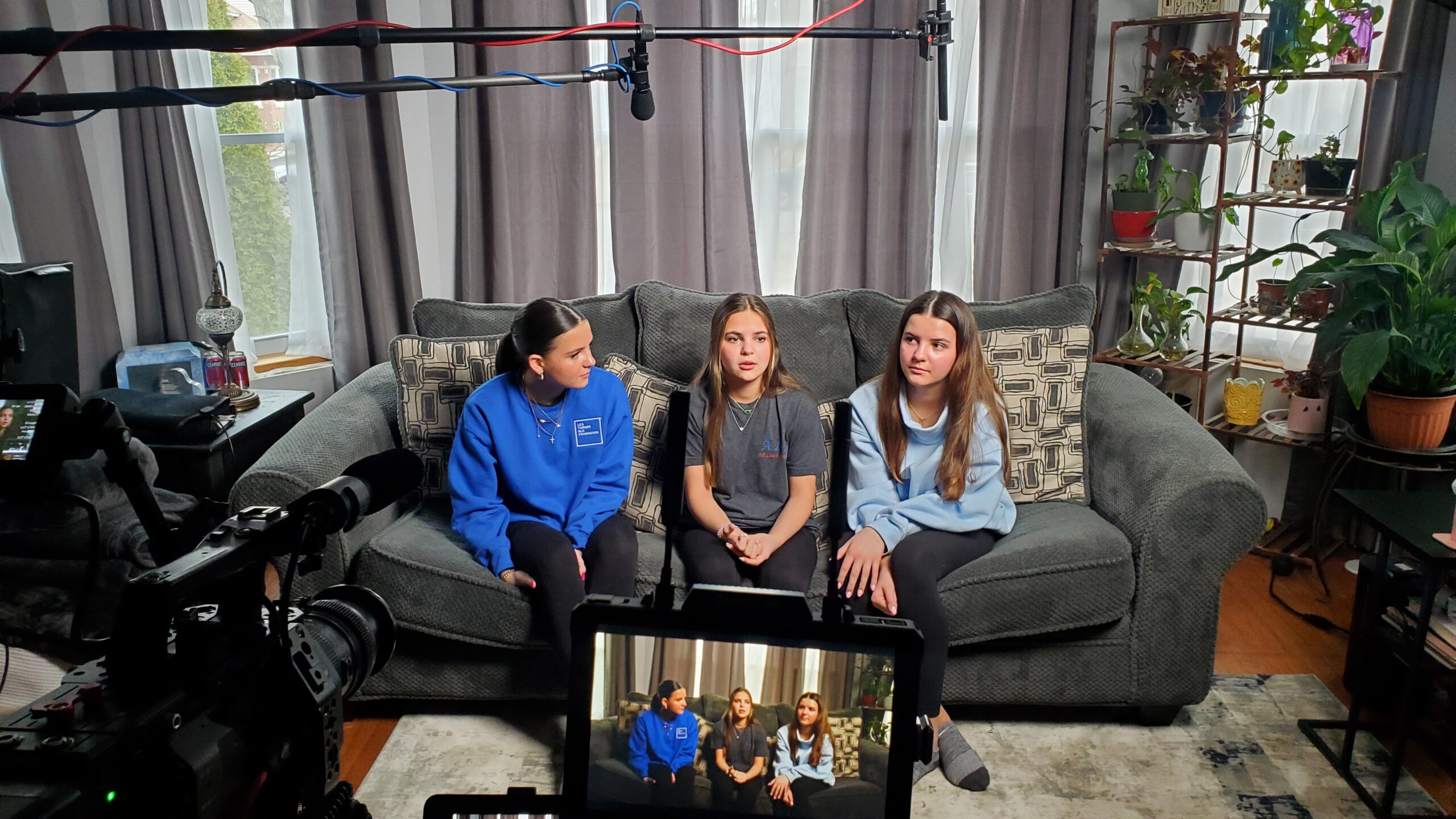 The Kostrzeski daughters sitting on the living room couch being interviewed